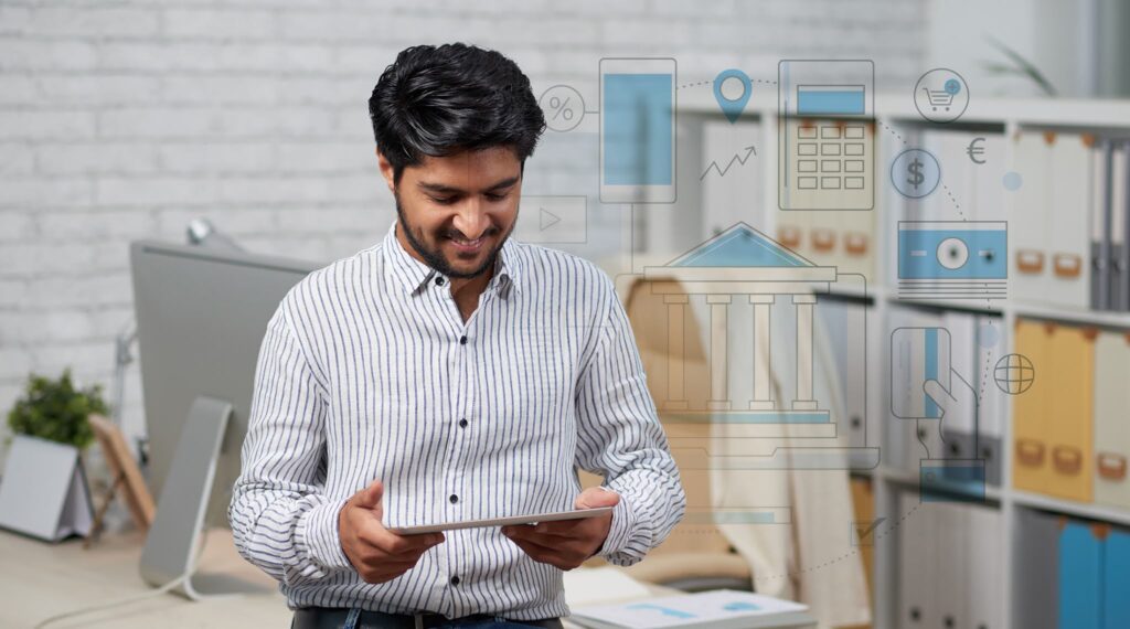 Tangentia | Smiling Indian entrepreneur reading news on digital tablet