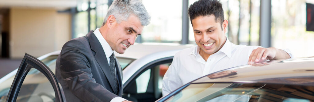 Tangentia|car salesman showing a new car to customer