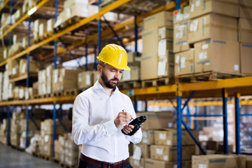 Tangentia|Warehouse worker or supervisor with barcode scanner.